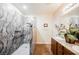 Modern bathroom featuring a walk-in shower, granite countertops, and dual sinks at 132 Soaring Sky Ave, Henderson, NV 89011