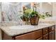 Bathroom featuring dual sinks with granite countertops and decorative flowers at 132 Soaring Sky Ave, Henderson, NV 89011