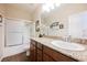 Bathroom highlighting a granite countertop, shower, and framed mirror at 132 Soaring Sky Ave, Henderson, NV 89011