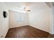 Bright bedroom showcasing a ceiling fan, wood floors, and natural light from the window at 132 Soaring Sky Ave, Henderson, NV 89011