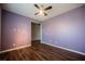 Bedroom featuring hardwood floors, a ceiling fan, and light purple walls at 132 Soaring Sky Ave, Henderson, NV 89011