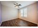 Bedroom featuring hardwood floors, a ceiling fan, and a large window at 132 Soaring Sky Ave, Henderson, NV 89011