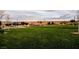 Expansive grassy area in the community park with covered picnic pavilions and mature trees in the background at 132 Soaring Sky Ave, Henderson, NV 89011