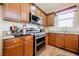 Close-up showcasing the stainless steel range, granite countertops, and wooden cabinets in the spacious kitchen at 132 Soaring Sky Ave, Henderson, NV 89011