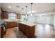 Open-concept kitchen with a granite island and stainless steel appliances, flowing into the adjacent living area at 132 Soaring Sky Ave, Henderson, NV 89011