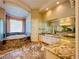 Luxurious bathroom featuring marble floors, a vanity, glass shower, and tub at 2017 Eagle Trace Way, Las Vegas, NV 89117
