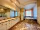 Spacious bathroom with marble floors, a large vanity, shower, and tub at 2017 Eagle Trace Way, Las Vegas, NV 89117