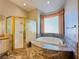 Bathroom with a marble countertop, a glass shower, and a bathtub at 2017 Eagle Trace Way, Las Vegas, NV 89117