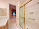 Bright bathroom with white tile, glass shower, and views into another room at 2017 Eagle Trace Way, Las Vegas, NV 89117