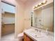 White-tiled bathroom with mirror, glass shower and walk-in closet at 2017 Eagle Trace Way, Las Vegas, NV 89117