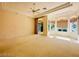 Bright bedroom featuring large windows, neutral carpet, and a ceiling fan at 2017 Eagle Trace Way, Las Vegas, NV 89117
