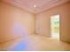 Well-lit bedroom with neutral walls and carpeting featuring a door leading to a walk-in closet at 2017 Eagle Trace Way, Las Vegas, NV 89117
