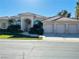 Elegant single-story home with a three-car garage and well-manicured front yard at 2017 Eagle Trace Way, Las Vegas, NV 89117