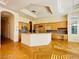 Large kitchen boasts ample cabinetry, an island with seating, and modern appliances at 2017 Eagle Trace Way, Las Vegas, NV 89117