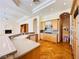 Spacious kitchen features custom wood cabinets, stone counter tops, modern appliances, and hardwood floors at 2017 Eagle Trace Way, Las Vegas, NV 89117