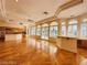 Spacious open floorplan with kitchen featuring a large island, custom cabinets, wood floors, and lots of natural light at 2017 Eagle Trace Way, Las Vegas, NV 89117