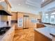Gourmet kitchen with custom cabinets, stainless appliances including double oven and refrigerator at 2017 Eagle Trace Way, Las Vegas, NV 89117