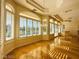 Bright and airy living room featuring beautiful hardwood floors and large windows with plantation shutters at 2017 Eagle Trace Way, Las Vegas, NV 89117
