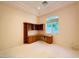 Comfortable office area features carpet, neutral walls, built-in desk and shelving at 2017 Eagle Trace Way, Las Vegas, NV 89117