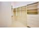 Walk-in closet with built-in shelving and drawers for storage at 2017 Eagle Trace Way, Las Vegas, NV 89117