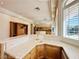 Kitchen wet bar with custom cabinets, stone countertops, and a view of the living area at 2017 Eagle Trace Way, Las Vegas, NV 89117