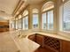 Kitchen wet bar area with stone counter tops, custom cabinets with wine rack, and natural light at 2017 Eagle Trace Way, Las Vegas, NV 89117