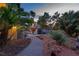 Lush backyard featuring a garden shed and multiple seating areas at 2222 Lucerne Ct, Henderson, NV 89014