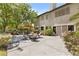 Spacious backyard with stone patio, outdoor seating, and lush landscaping at 2222 Lucerne Ct, Henderson, NV 89014