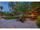 Relaxing backyard patio with a dining area and lush green landscaping at 2222 Lucerne Ct, Henderson, NV 89014