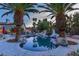 Stunning backyard pool with a slide, surrounded by palm trees at 2222 Lucerne Ct, Henderson, NV 89014