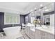 Bright bathroom with a stand-alone tub, double sink vanity, and stylish decor at 2222 Lucerne Ct, Henderson, NV 89014
