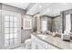 Bathroom featuring a vanity with a gray countertop, framed mirror, and white door to the outside at 2222 Lucerne Ct, Henderson, NV 89014