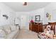 Cozy bedroom with neutral paint, wood dresser, and comfortable seating at 2222 Lucerne Ct, Henderson, NV 89014