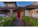 Inviting front entrance with a red door and blooming flower bushes at 2222 Lucerne Ct, Henderson, NV 89014