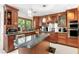 Well-appointed kitchen boasts custom wood cabinets, granite countertops, stainless steel appliances, and an island for prep work at 2222 Lucerne Ct, Henderson, NV 89014