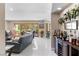 Bright living room with a bar area, featuring tile floors, sliding glass doors, and access to the backyard at 2222 Lucerne Ct, Henderson, NV 89014