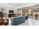 Spacious living room with tile floors, comfortable seating, entertainment center, and access to the outdoor area at 2222 Lucerne Ct, Henderson, NV 89014