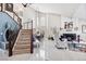 Elegant living room featuring high ceilings, a staircase, and a cozy fireplace at 2222 Lucerne Ct, Henderson, NV 89014