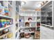 Walk-in pantry with white shelves stocked with food and beverage items, including a beverage refrigerator at 2222 Lucerne Ct, Henderson, NV 89014