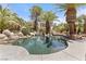 Beautiful pool with mature landscaping, slide and rock features at 2222 Lucerne Ct, Henderson, NV 89014