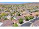 Overhead drone shot of a beautiful residential neighborhood with well-maintained lawns and a mountain backdrop at 2544 Ashley Rose Ter, Henderson, NV 89052