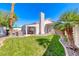 Lush backyard featuring a sparkling swimming pool, manicured lawn, and beautiful landscaping at 2544 Ashley Rose Ter, Henderson, NV 89052