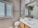 A bright bathroom features a single vanity, toilet, and plantation shutters at 2544 Ashley Rose Ter, Henderson, NV 89052