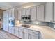 Well-equipped kitchen with gray cabinets, stainless appliances, tiled backsplash, and wooden floor at 2544 Ashley Rose Ter, Henderson, NV 89052