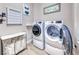 Well-organized laundry room with front-load washer/dryer and storage for laundry supplies at 2544 Ashley Rose Ter, Henderson, NV 89052