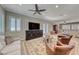 Inviting living room showcasing wood flooring, a ceiling fan, and neutral décor at 2544 Ashley Rose Ter, Henderson, NV 89052