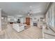 Spacious living room with wood floors, shutters, fireplace, and open layout to dining area at 2544 Ashley Rose Ter, Henderson, NV 89052