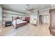 A spacious main bedroom features hardwood floors, a ceiling fan, and ample room for bedroom furniture at 2544 Ashley Rose Ter, Henderson, NV 89052