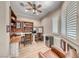 Home office featuring wood floors, built-in shelves, and a workstation with dual desks at 2544 Ashley Rose Ter, Henderson, NV 89052