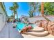 Inviting backyard pool and spa with rock waterfall feature, surrounded by lush landscaping and palm trees at 2544 Ashley Rose Ter, Henderson, NV 89052
